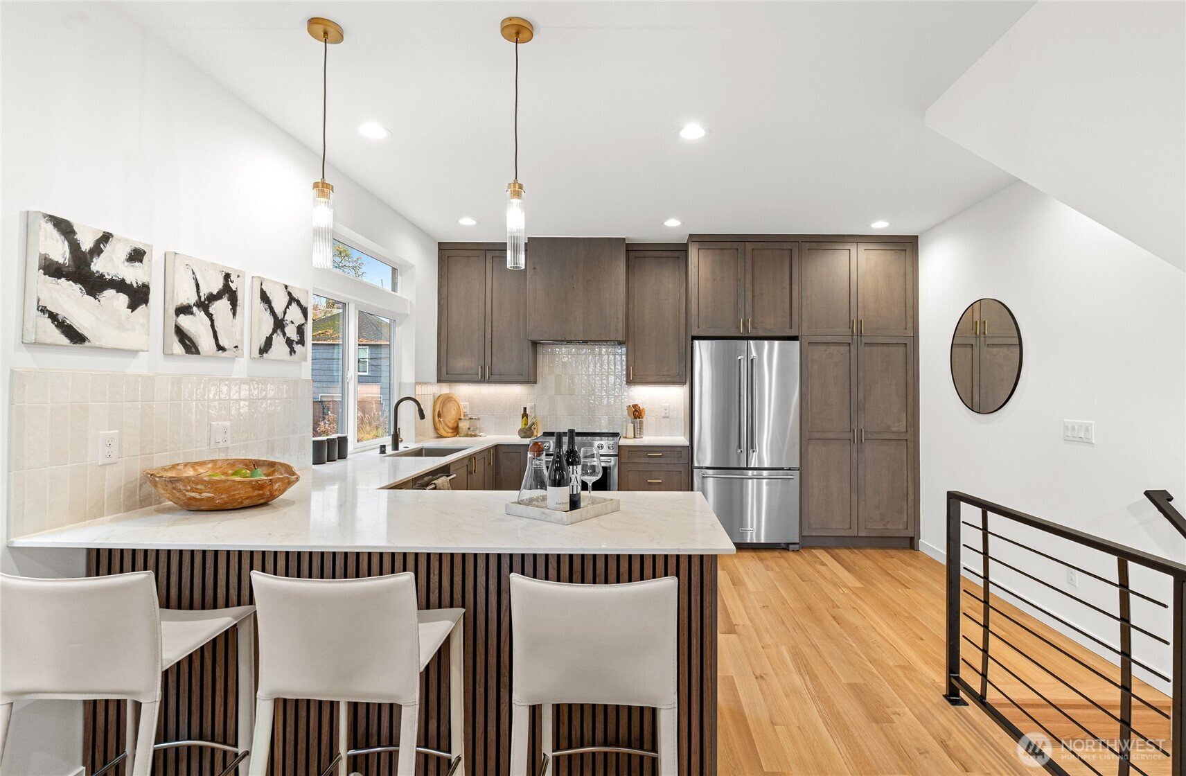 311 17th Avenue East Seattle, WA 98112 - Photo 14 of 39 a kitchen with stainless steel appliances granite countertop a stove a refrigerator a oven a sink with a countertop and chairs