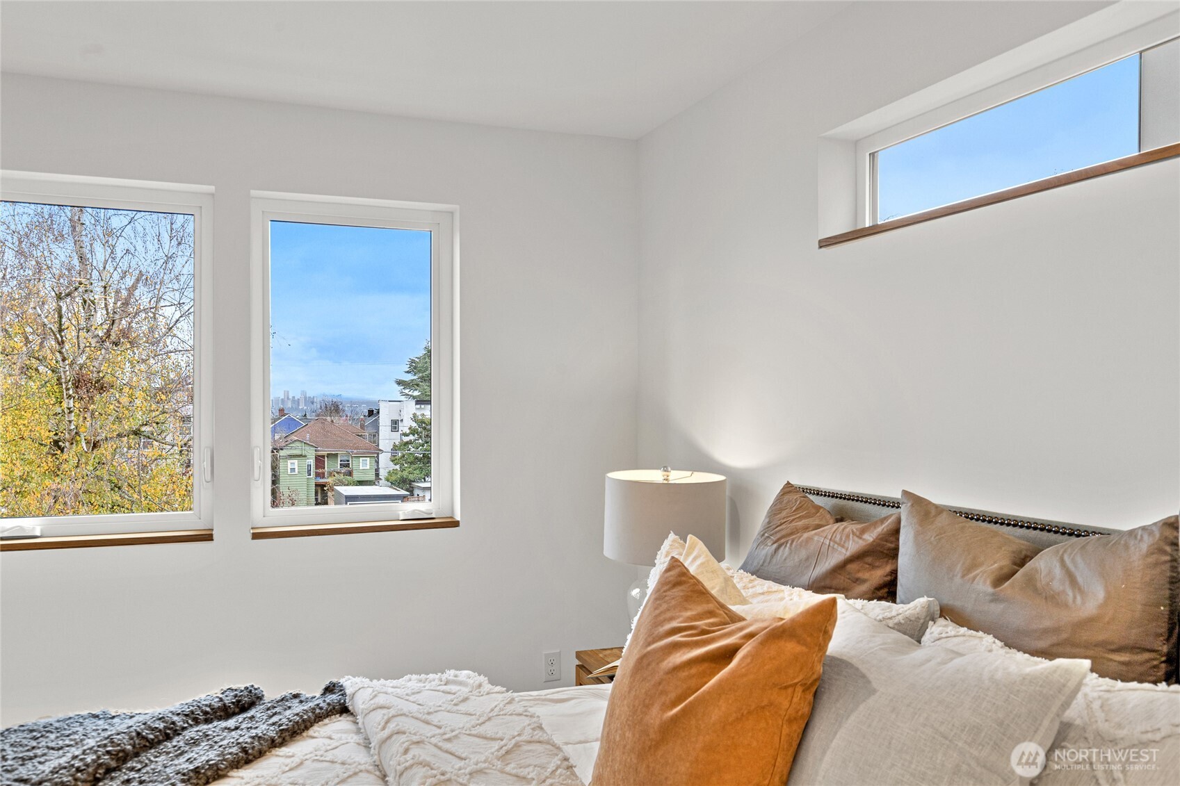 311 17th Avenue East Seattle, WA 98112 - Photo 24 of 39 a bed sitting in a bedroom next to a window
