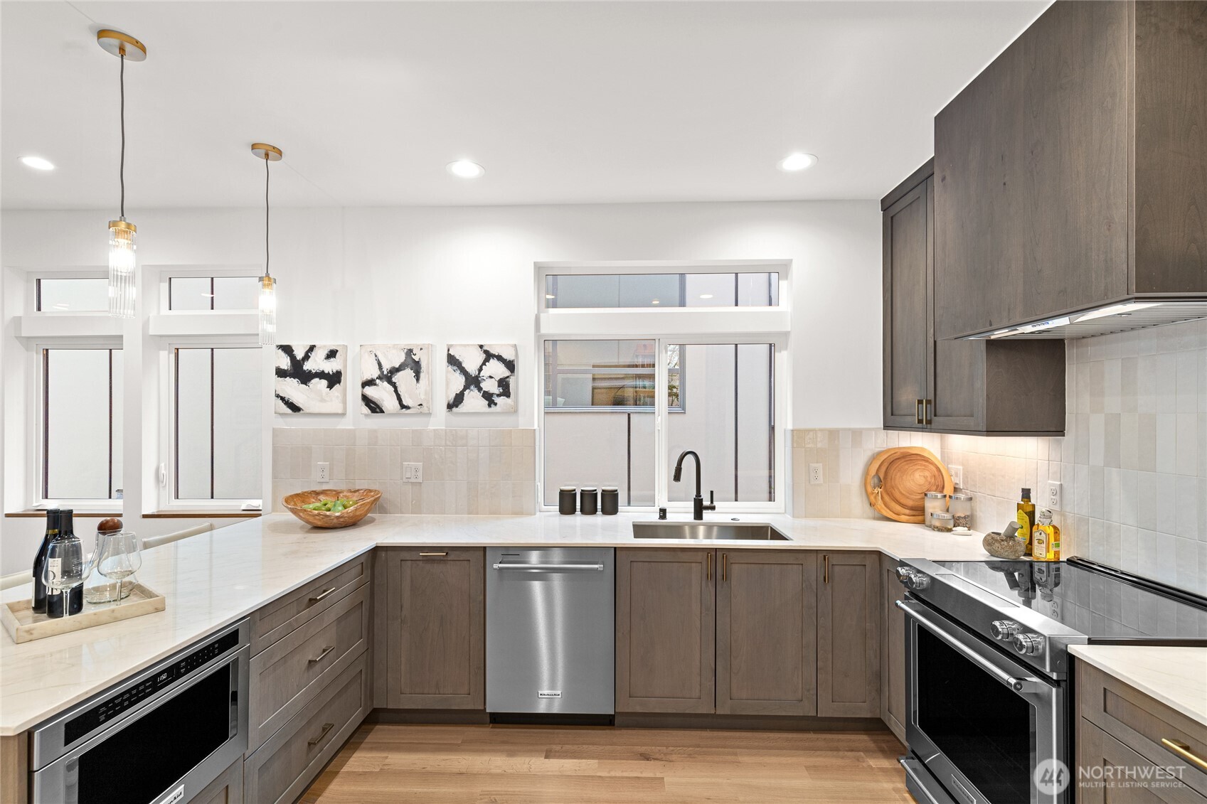 311 17th Avenue East Seattle, WA 98112 - Photo 10 of 39 a kitchen with stainless steel appliances granite countertop a sink stove and cabinets