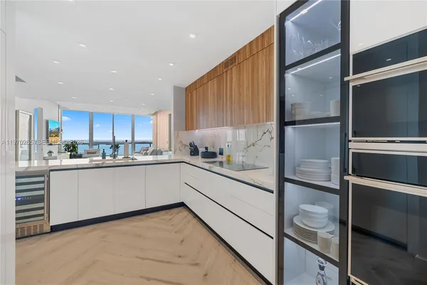 a kitchen with white cabinets and refrigerator