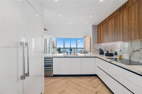 a kitchen with stainless steel appliances granite countertop a refrigerator sink and cabinets