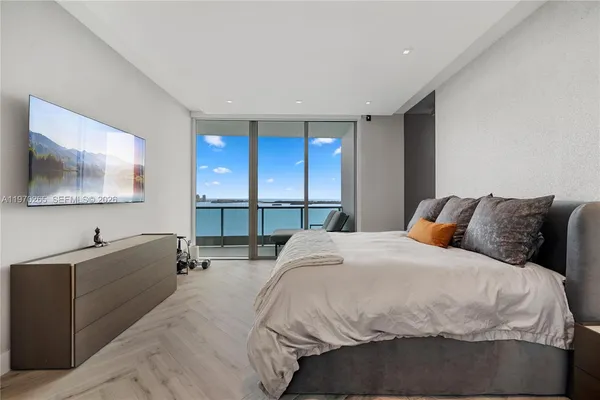a bedroom with furniture and a potted plant