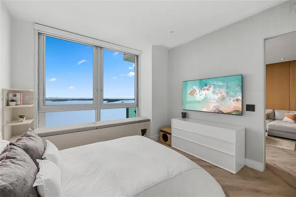 a bedroom with a bed and a flat screen tv