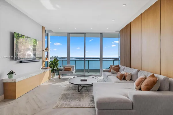 a living room with furniture and a large window