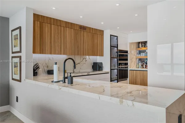 a view of a kitchen with a sink and a faucet