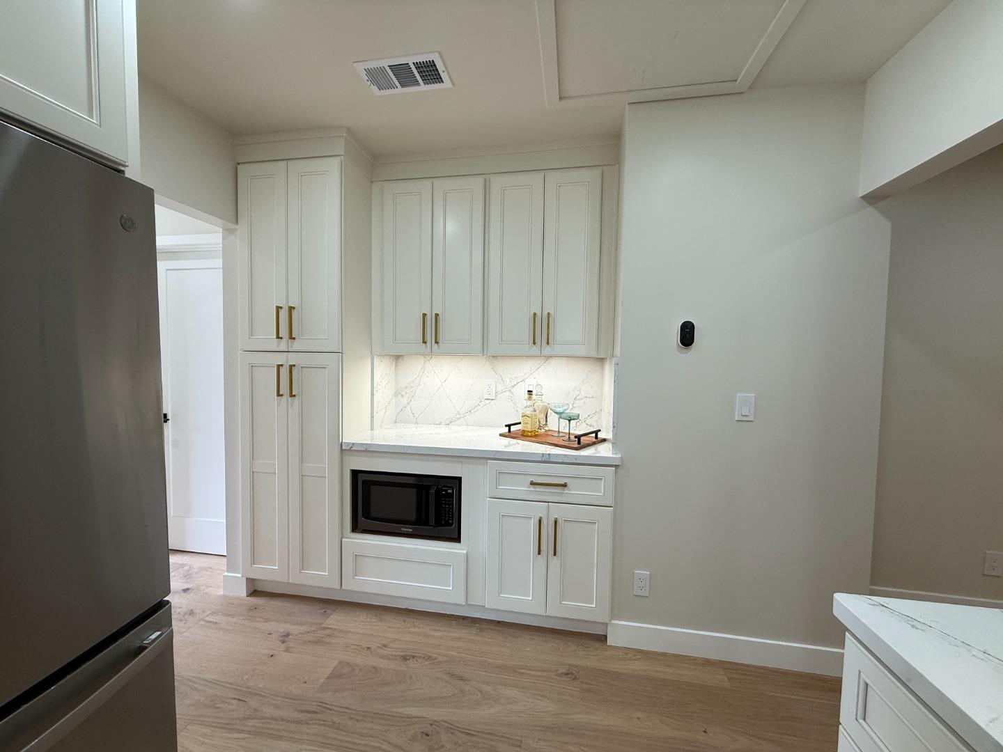 199 South 23rd Street San Jose, CA 95116 - Photo 14 of 33 a kitchen with stainless steel appliances a white cabinet and a stove top oven