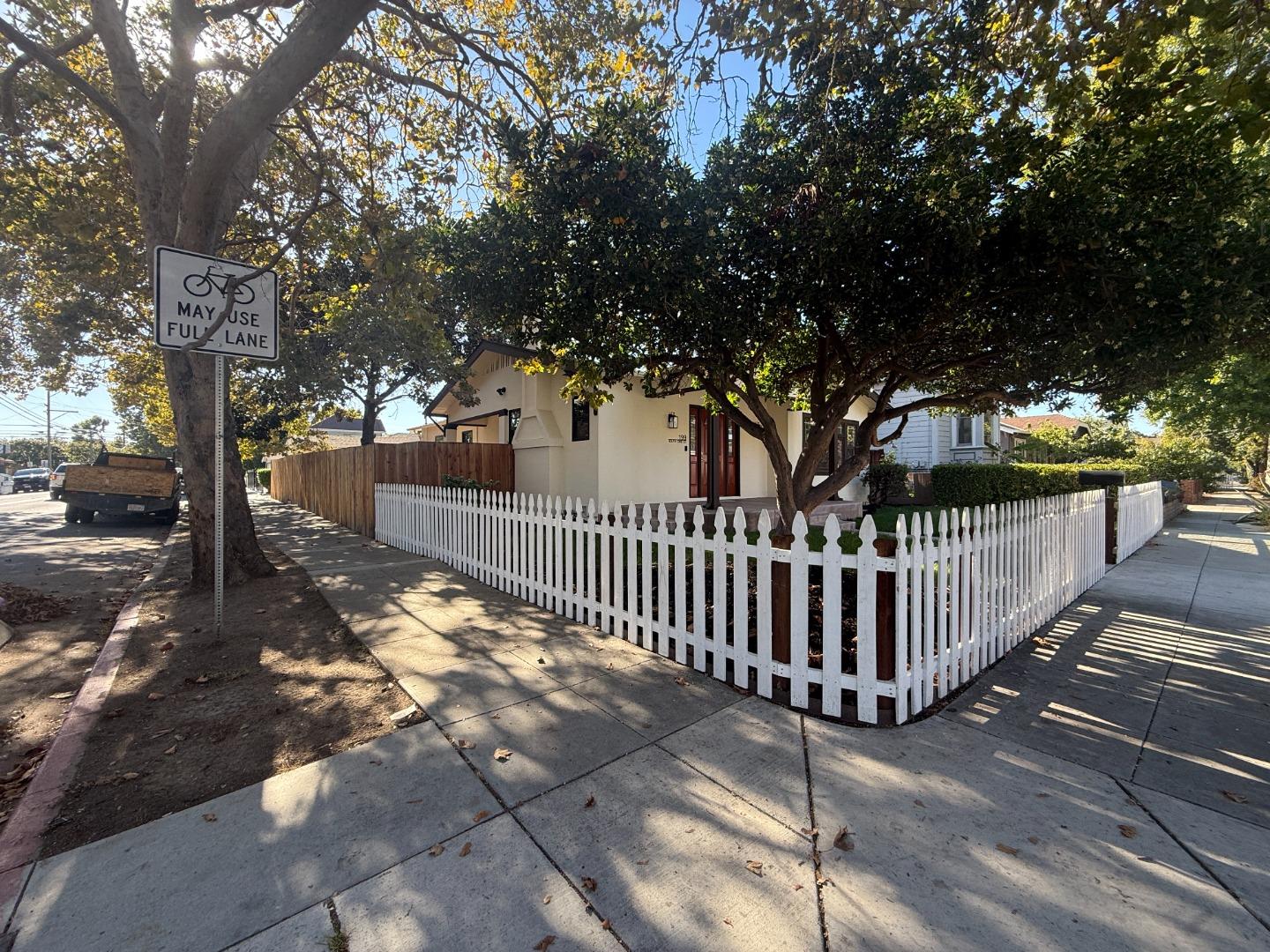 199 South 23rd Street San Jose, CA 95116 - Photo 3 of 33 a view of a yard with wooden fence and trees