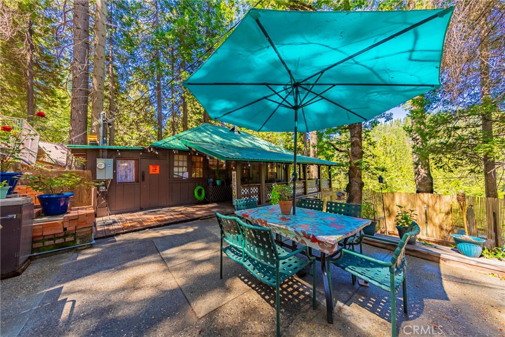 49988 Locust Road Oakhurst, CA 93644 - Photo 13 of 35 a view of a patio with a table and chairs under an umbrella