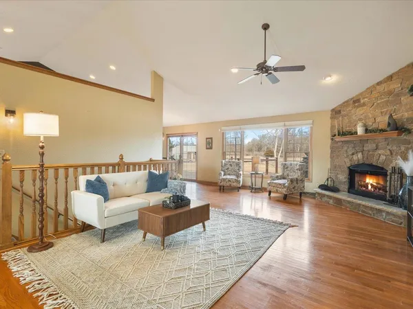 a kitchen with stainless steel appliances granite countertop dining table chairs and chandelier