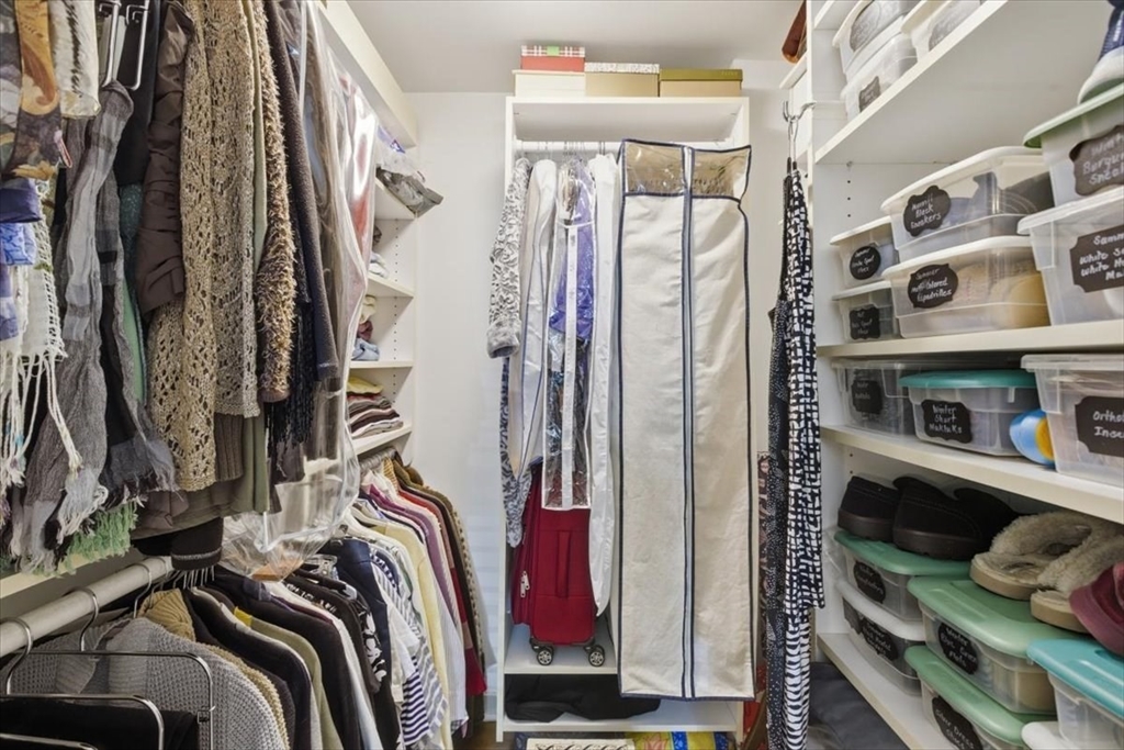 65 Glen Road, Unit H1 Brookline, MA 02445 - Photo 26 of 39 a view of walk in closet with clothes and shoes