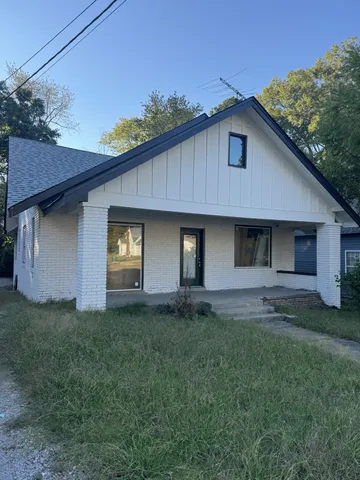 a house with lots of trees in the background