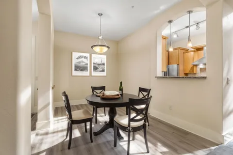 a view of a dining room with furniture and a chandelier