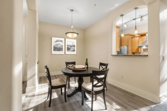 a view of a dining room with furniture and a chandelier