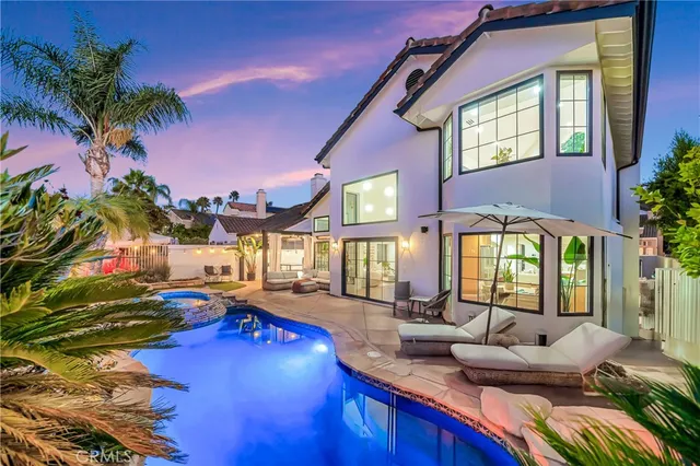a view of a house with swimming pool and sitting area