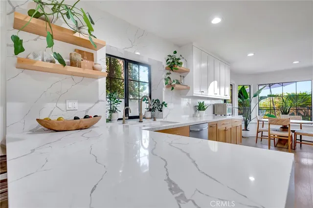 a kitchen with a table chairs stove and wooden floor