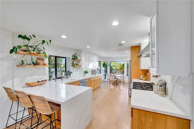 a kitchen with granite countertop a stove and a refrigerator