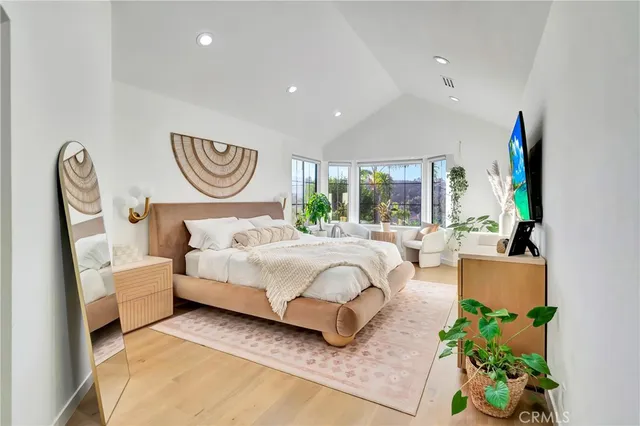 a spacious bedroom with a bed and a couch