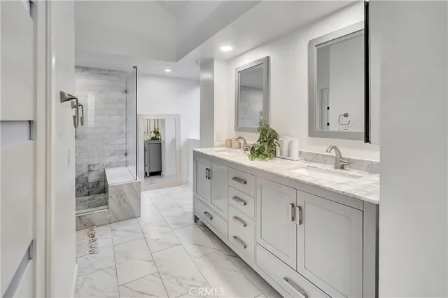 a spacious bathroom with a double vanity sink and a mirror