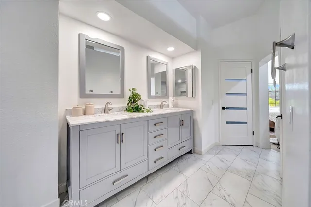 a bedroom with furniture and a large window