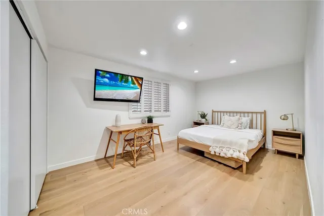 a bedroom with furniture and a flat screen tv