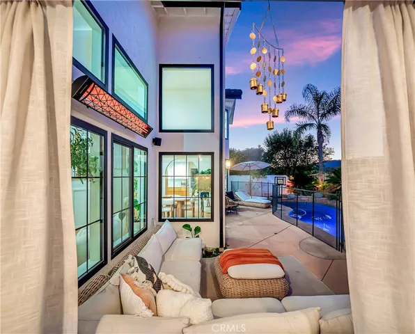 a room with lots of furniture and a potted plant