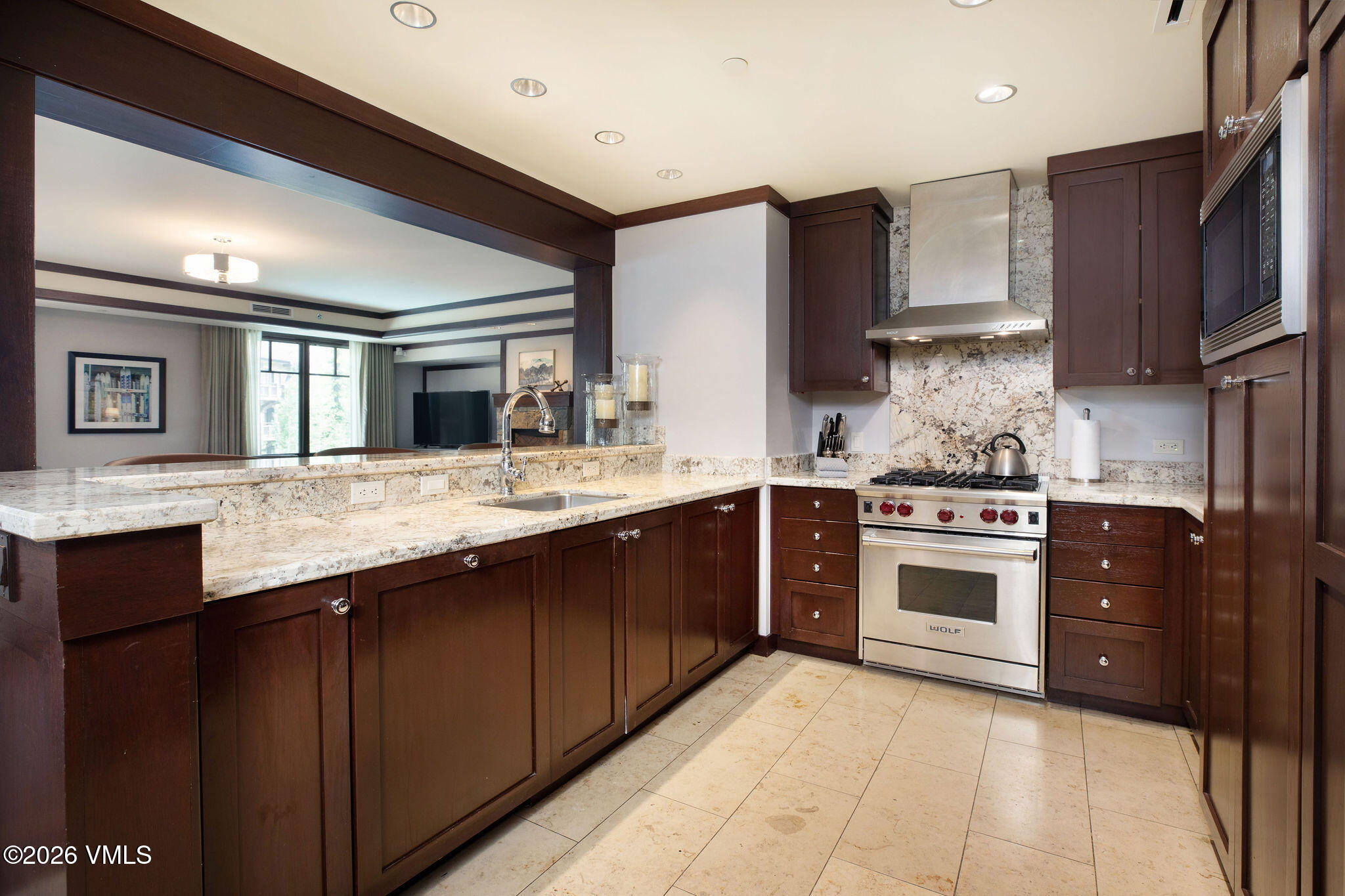 1 Vail Road, Unit 5102J Vail, CO 81657 - Photo 4 of 26 a kitchen with stainless steel appliances granite countertop a sink stove and refrigerator