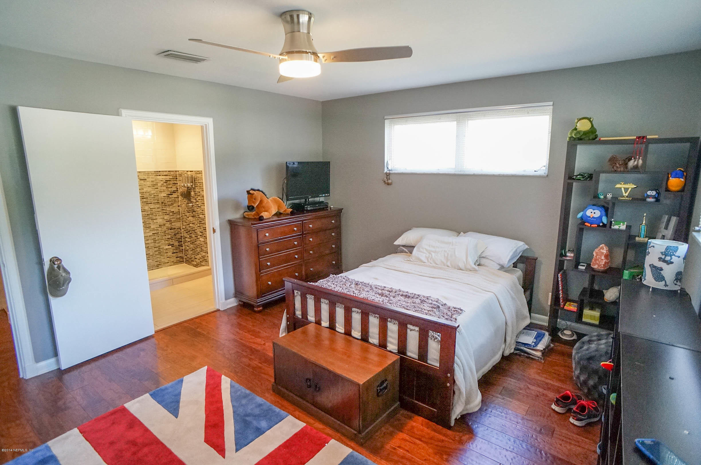 2132 La Vaca Road Jacksonville, FL 32217 - Photo 34 of 42 a bedroom with a bed and wooden floor