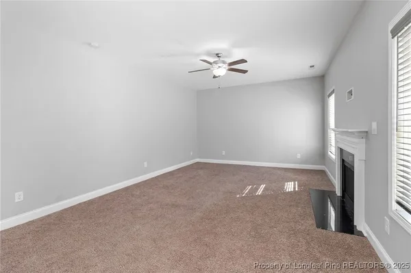 an empty room with a empty space and a ceiling fan