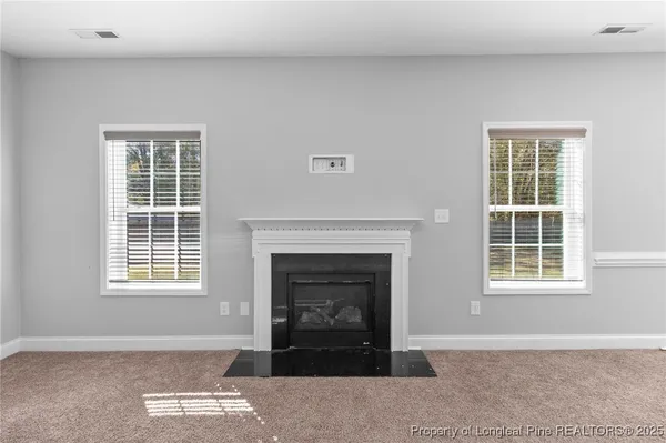 a living room with a fireplace and a window