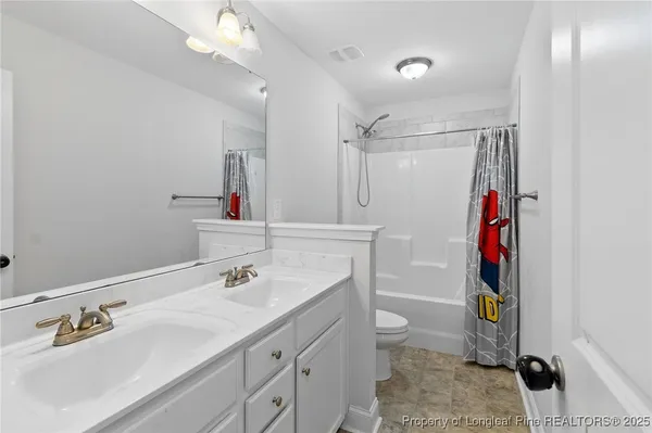 a bathroom with a sink vanity and a mirror