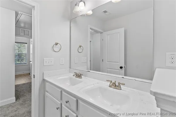 a bathroom with a sink double vanity and a mirror