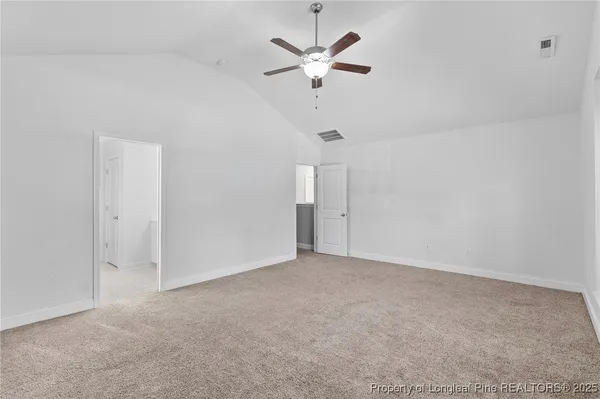 an empty room with a ceiling fan and a ceiling fan