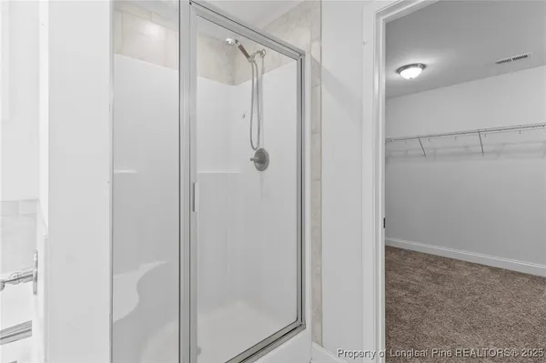 a bathroom with a glass shower door