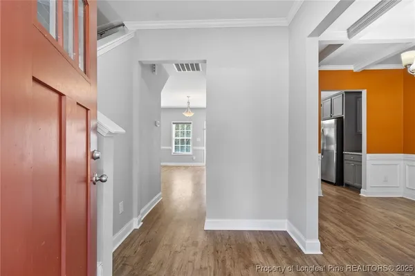 a view of hallway with wooden floor