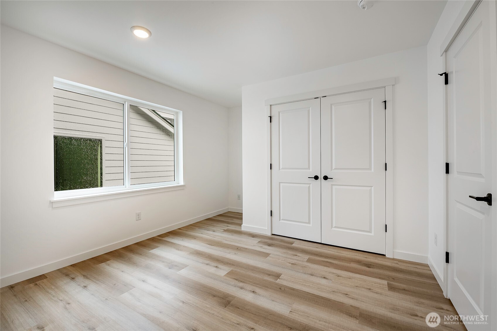2999 Cedar View Road Blaine, WA 98230 - Photo 26 of 37 a view of an empty room with wooden floor and a window