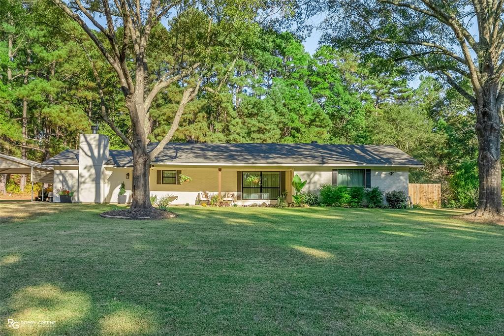 146 Bolinger Hill Road Plain Dealing, LA 71064 - Photo 1 of 32 a front view of a house with a garden