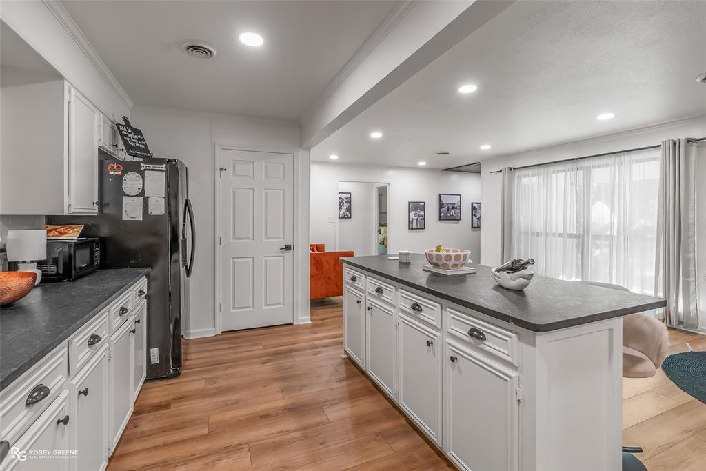 146 Bolinger Hill Road Plain Dealing, LA 71064 - Photo 11 of 32 a kitchen with stainless steel appliances granite countertop a sink stove and refrigerator