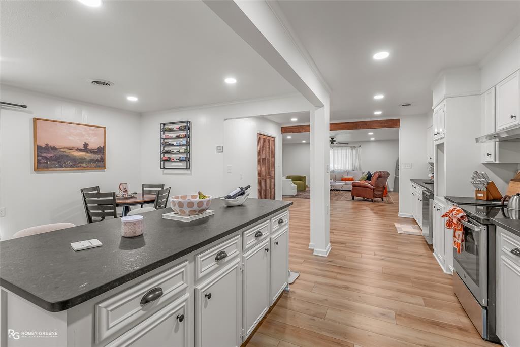 146 Bolinger Hill Road Plain Dealing, LA 71064 - Photo 12 of 32 a kitchen with sink stove and wooden floor