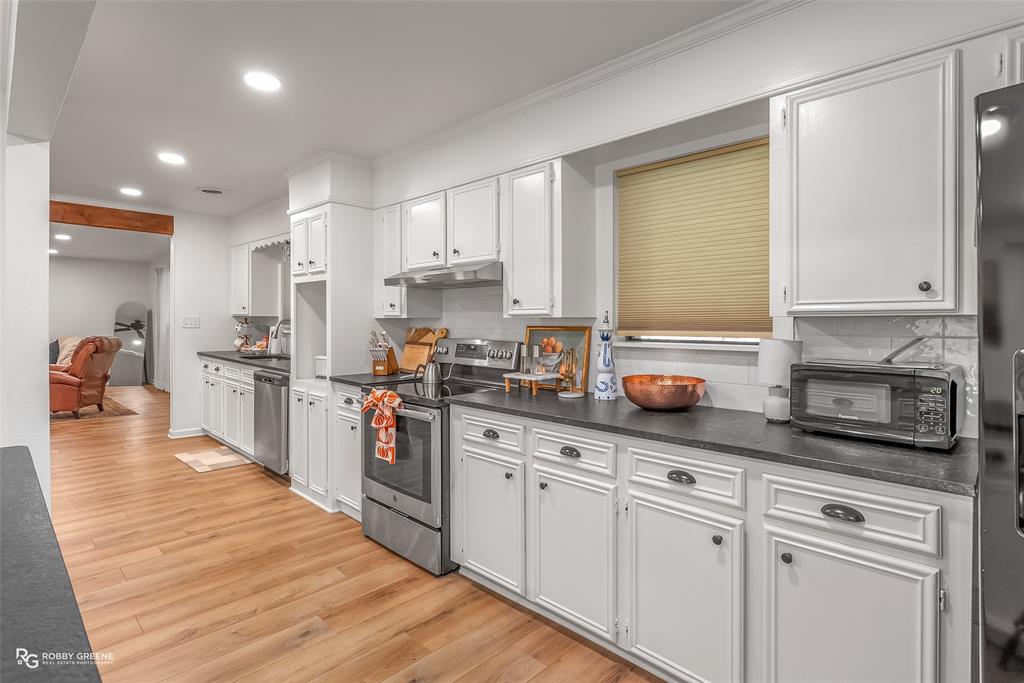 146 Bolinger Hill Road Plain Dealing, LA 71064 - Photo 13 of 32 a kitchen with stainless steel appliances granite countertop a sink a stove and cabinets