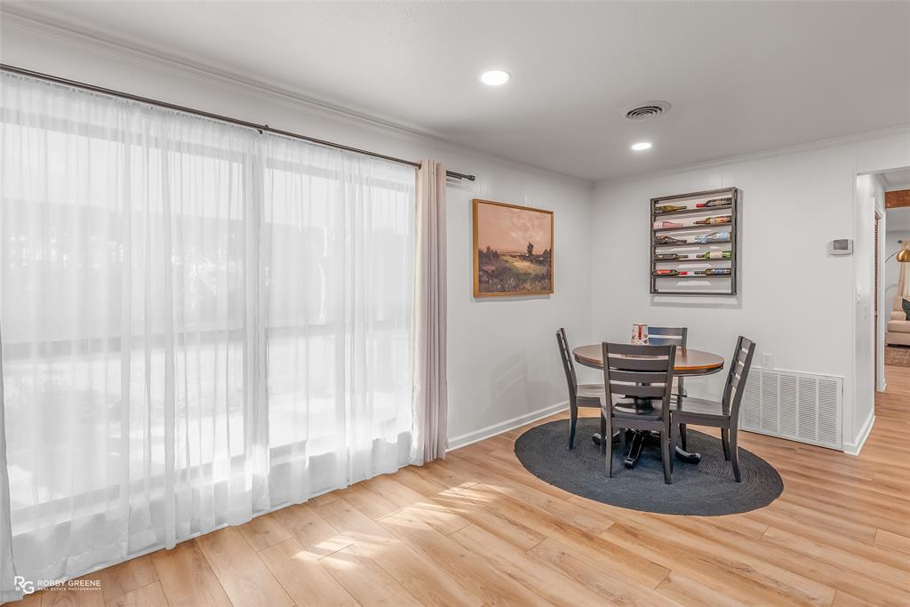 146 Bolinger Hill Road Plain Dealing, LA 71064 - Photo 16 of 32 a view of a dining room with furniture and wooden floor