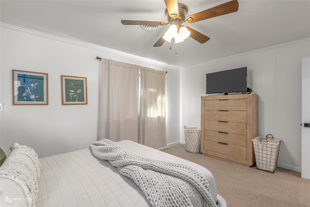 146 Bolinger Hill Road Plain Dealing, LA 71064 - Photo 20 of 32 a bedroom with a bed and a television