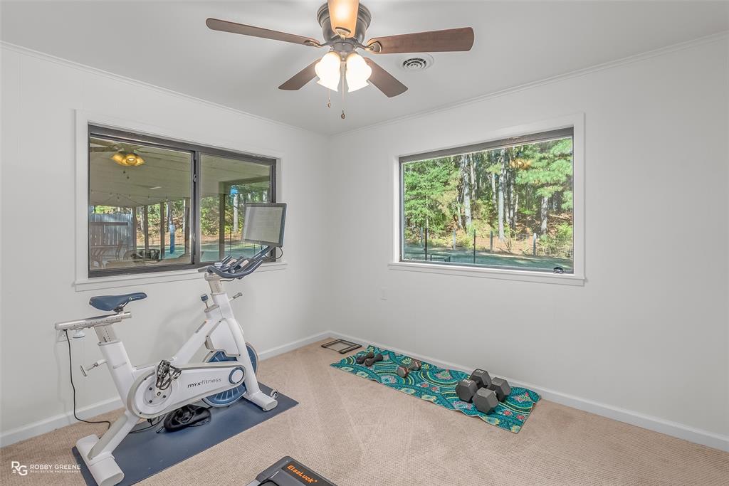 146 Bolinger Hill Road Plain Dealing, LA 71064 - Photo 24 of 32 a room with gym equipment and view of living room