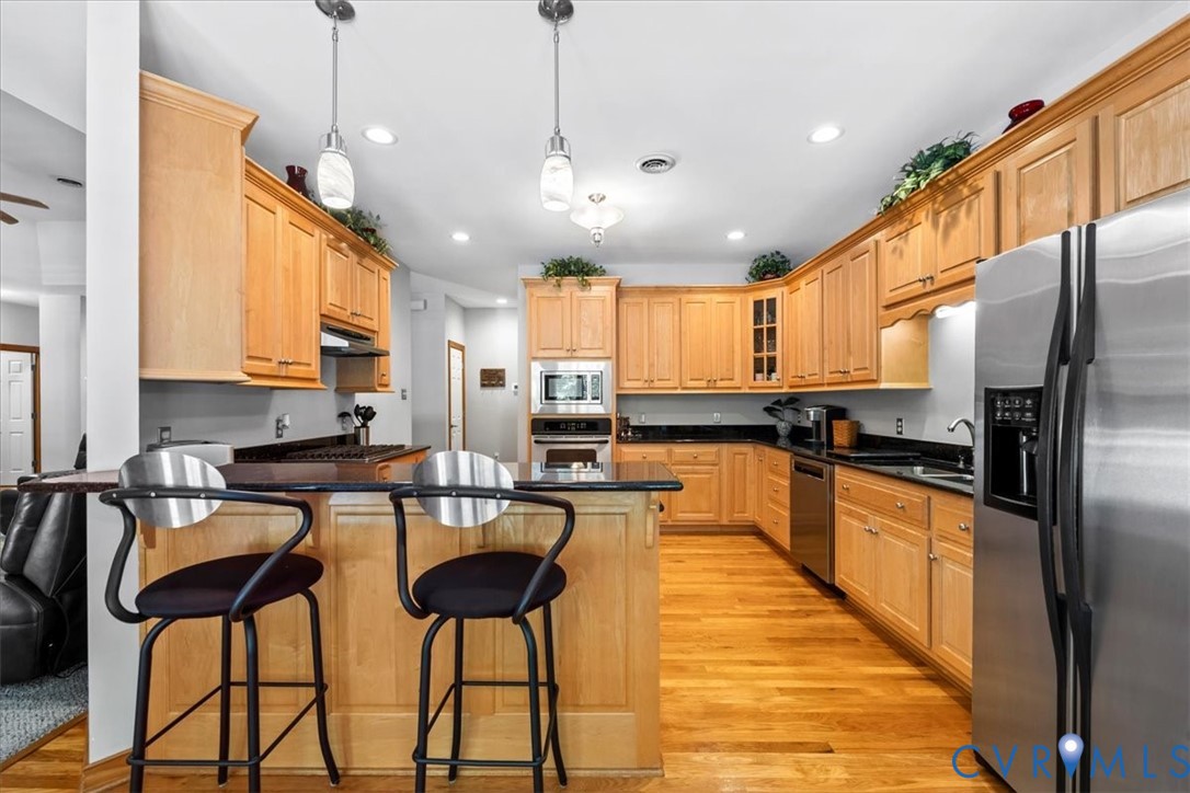 3060 Moyer Road Powhatan, VA 23139 - Photo 22 of 66 Chef's kitchen featuring warm wood cabinetry throu