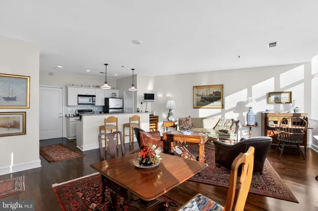 a living room with furniture kitchen view and a table