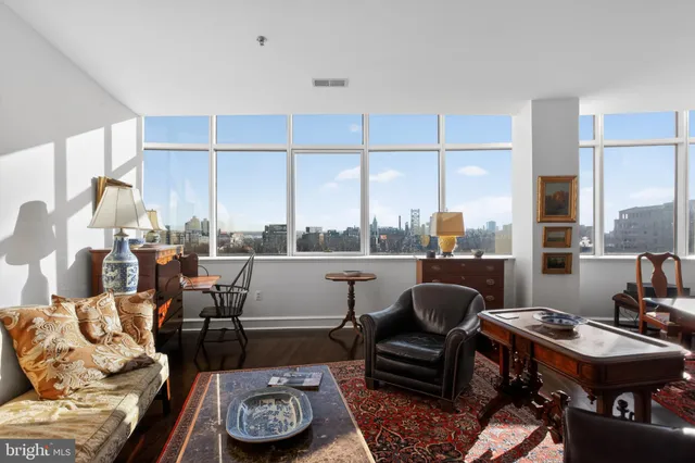 a living room with furniture and a floor to ceiling window