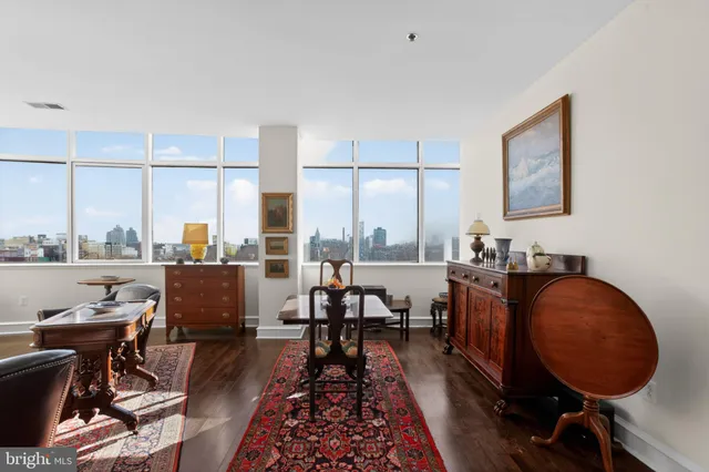 a living room with furniture and a floor to ceiling window