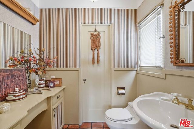 a view of a dining room with furniture a chandelier and wooden floor
