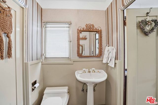 a dining room with furniture a chandelier and wooden floor