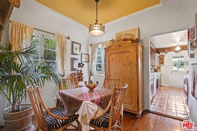 a spacious bedroom with a bed and wooden floor