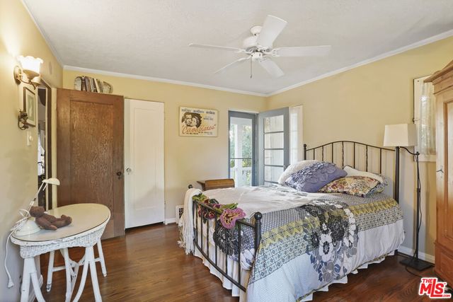a kitchen with granite countertop a sink and a stove top oven with white cabinets
